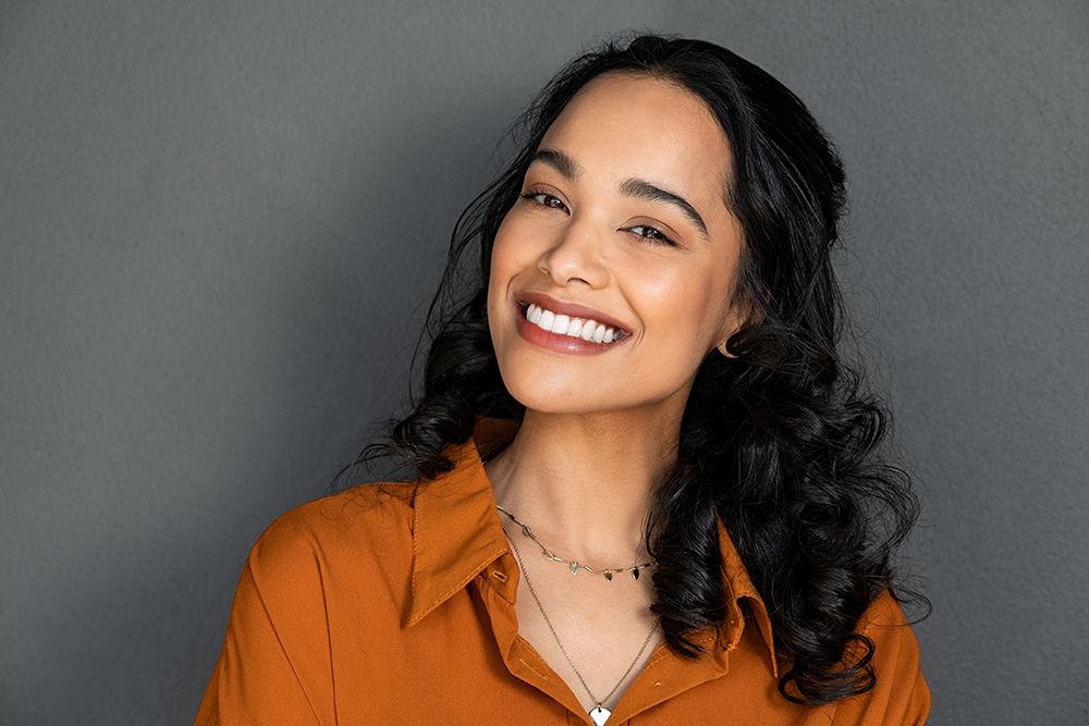 Beautiful woman smiles after receiving cosmetics treatment